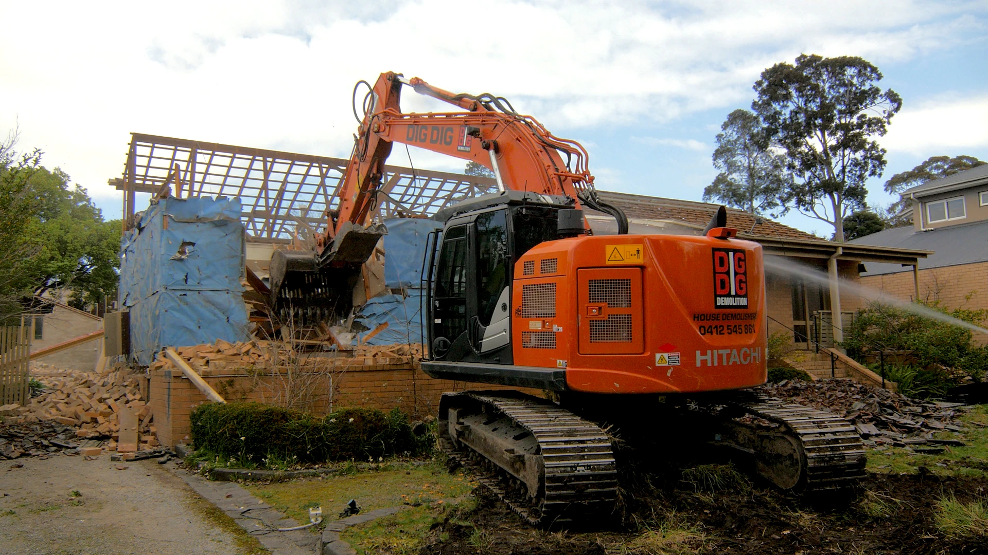 Excavator demolishing a single-storey brick home on a residential block in Melbourne's South East
