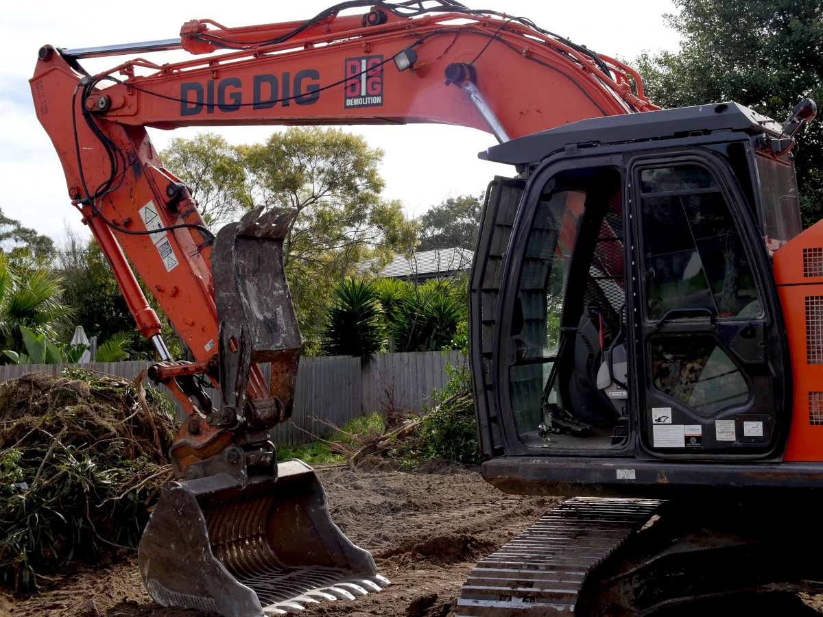 DigDig Demolition excavator and crew working on a cleared residential block in Carrum Downs